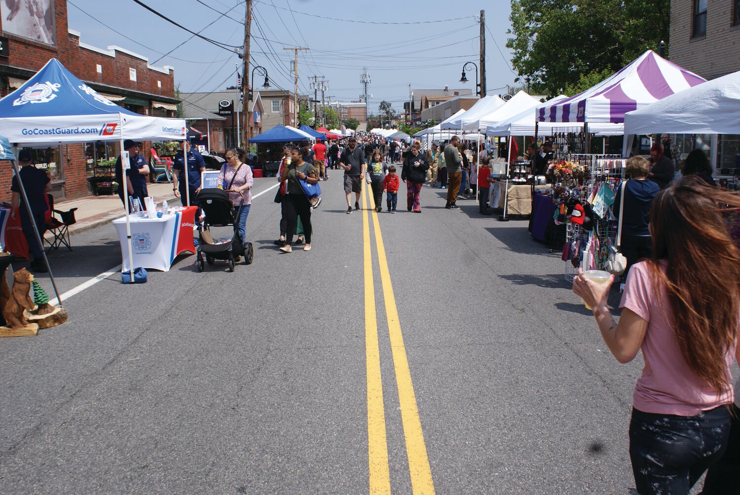 THE PATH MOST TAKEN: The entire street was closed down to accommodate the numerous vendors and give people a chance to safely walk the road with their children. Traffic and parking was still allowed on side streets so that all businesses on Rolfe Square could stay open during the festival.